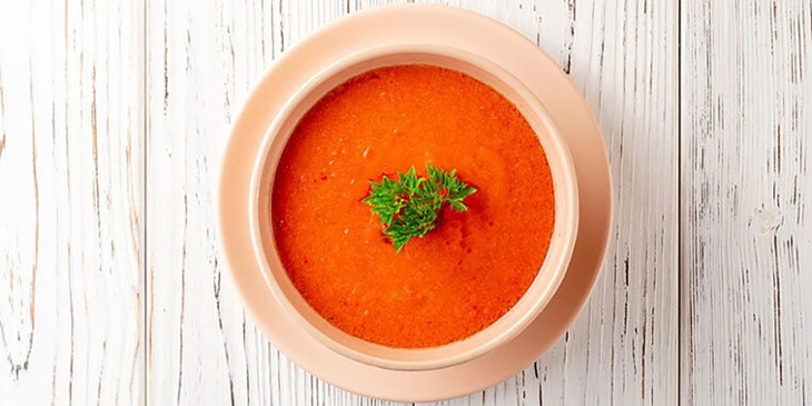 Keto buffalo sauce plated on ceramic bowls garnished with a fresh twig of parsley