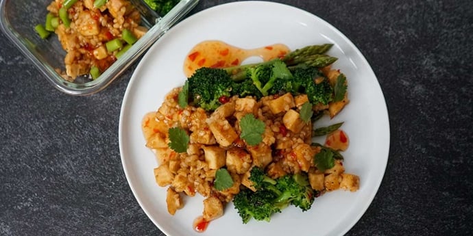 Easy Sweet and Sour Chicken Recipe plated on a white plate with vegetables and sauce