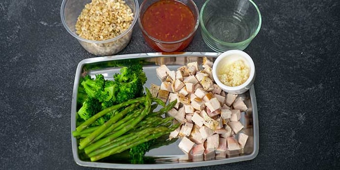 Easy Sweet and Sour Chicken Recipe ingredients prepared on glass containers and stainless steel tray