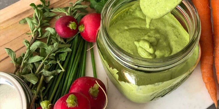 Green Goddess Sauce Recipe served on a round mason jar next to fresh produce