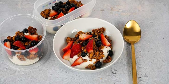 Paleo Coconut Yogurt Parfait Recipe Portioned into meal prep containers and a white bowl