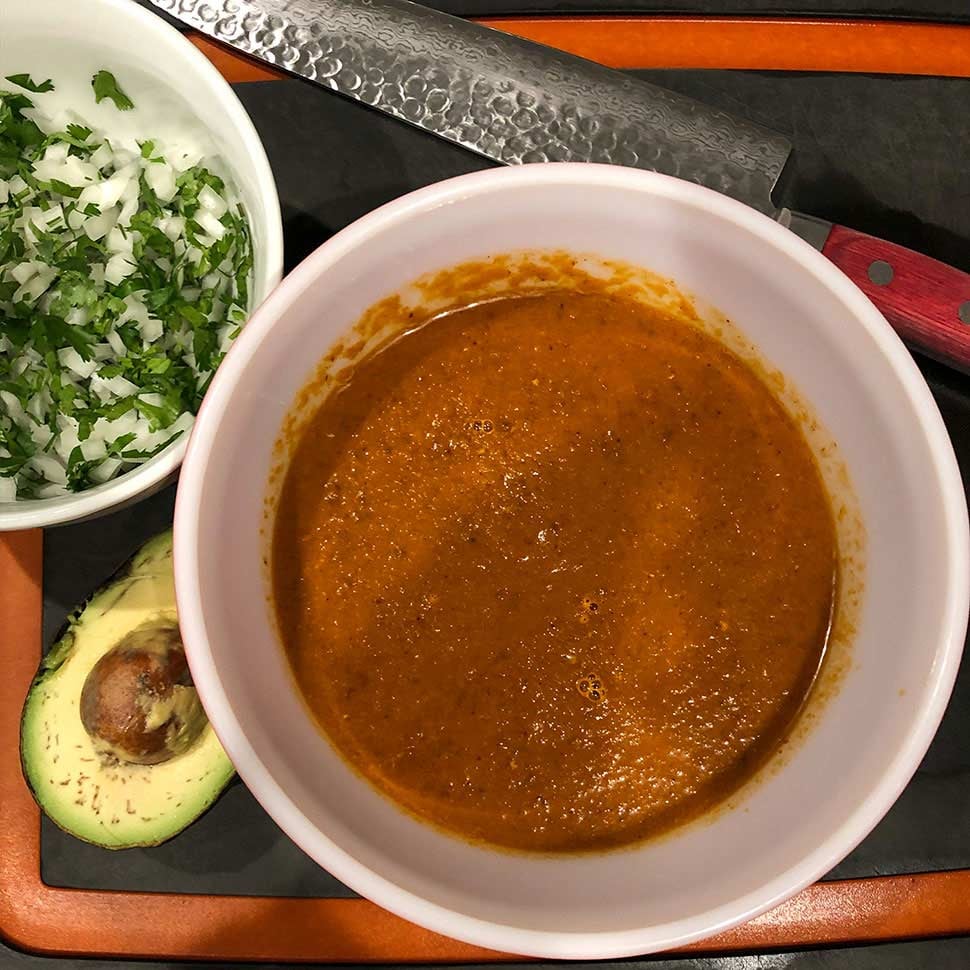 Quick-Steak-Birria-Tacos-Recipe-Ingredients-and-Sauce-with-Avocado-on-Cutting-Board