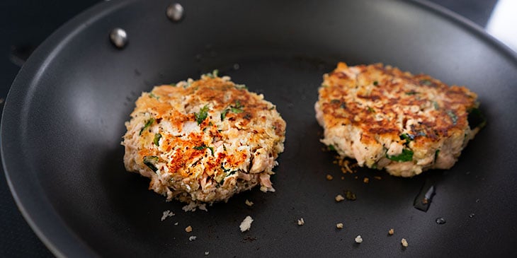 cooking salmon cakes in saute pan 