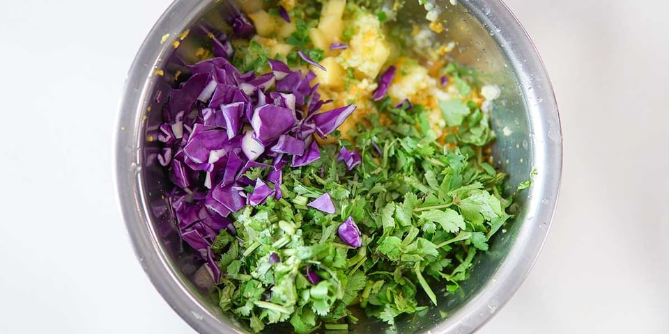 mixing ingredients for fresh turmeric mango salsa recipe 