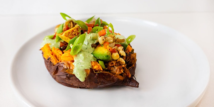 Vegan southwest stuffed sweet potato placed on a white plate