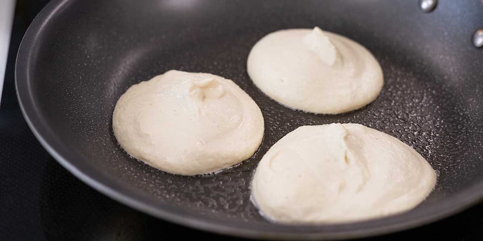 cooking keto pancakes in non-stick skillet 