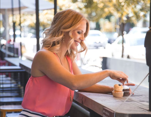 girl smiling at cupcake