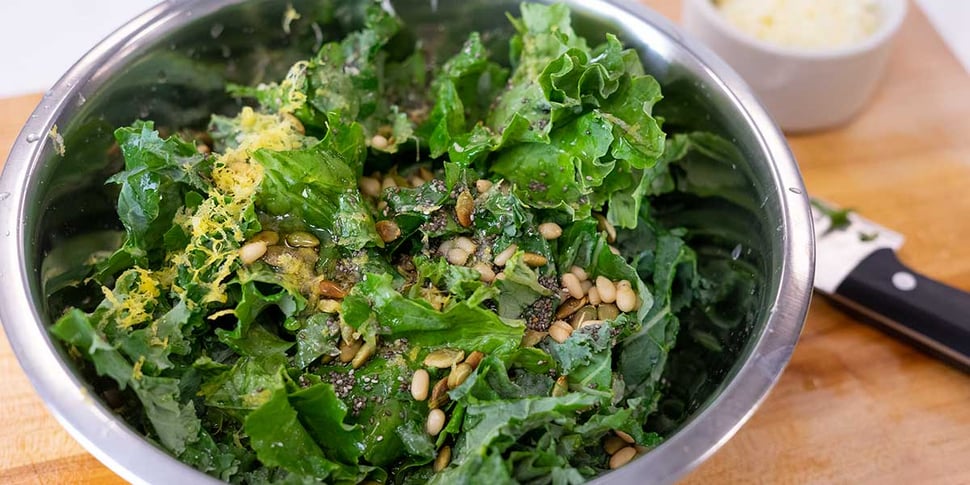 mixing lemon parm kale salad recipe for keto meal prep