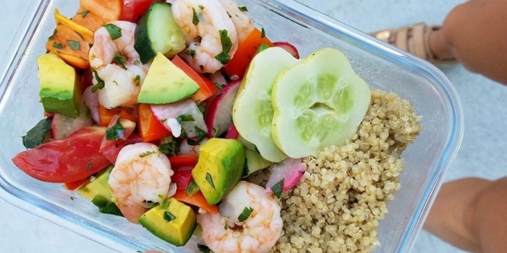Shrim ceviche recipe plated on a meal prep container with a side of white quinoa