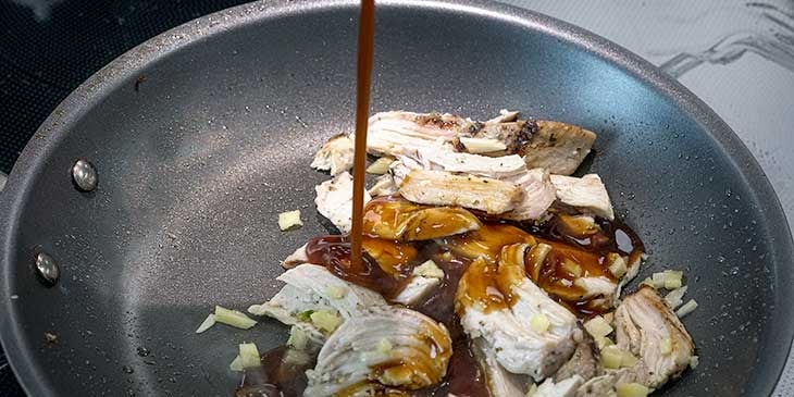 sauteing teriyaki chicken for pineapple bowl recipe in skillet 