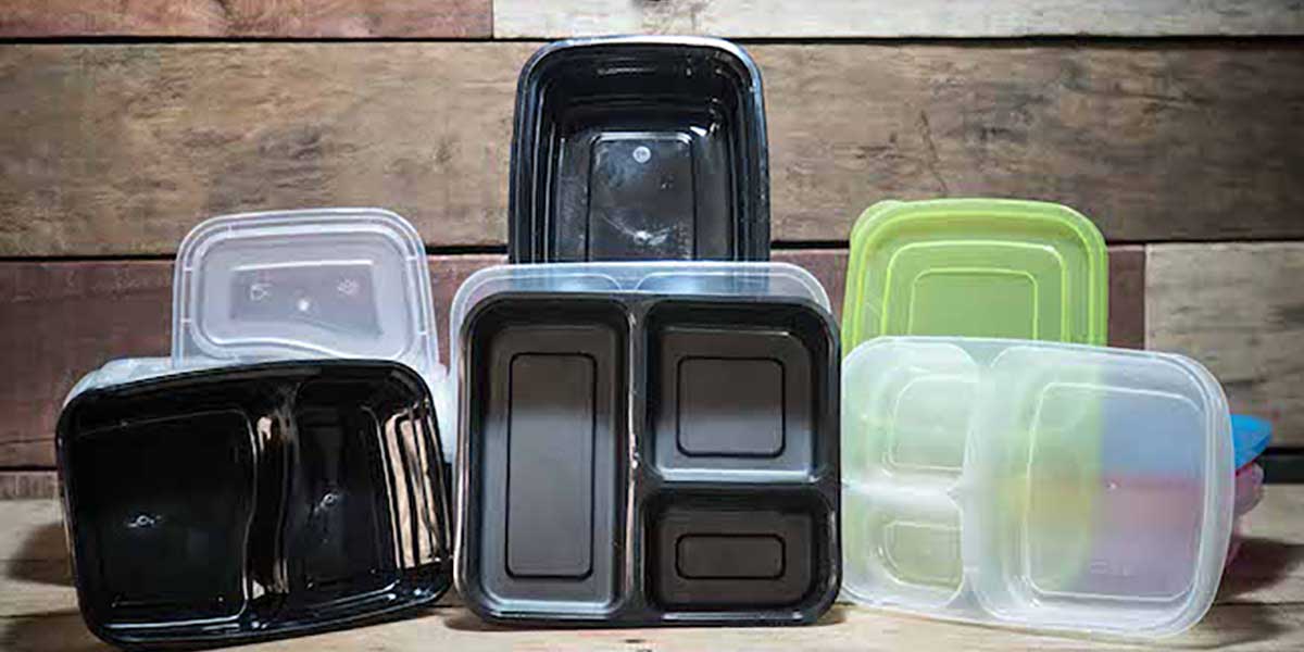 Meal Prep Containers: A Complete Review & 12 Best Containers various meal prep containers placed on a wooden table and backdrop