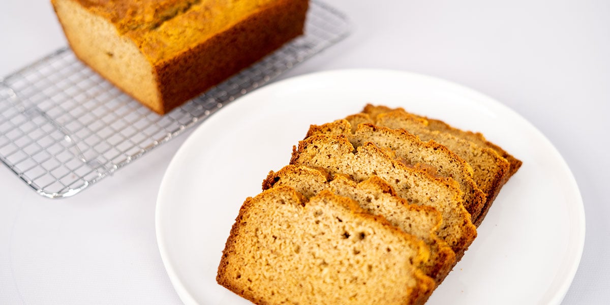 Paleo Gluten Free Bread Recipe Sliced and Whole on a Plate and Cooling Rack