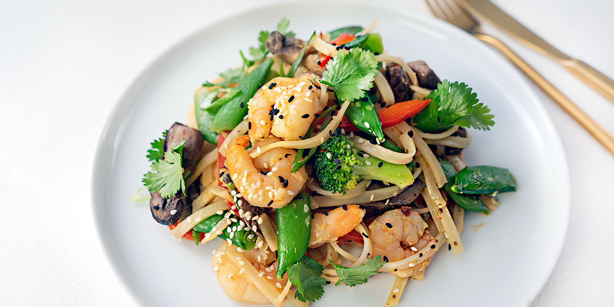shrimp stir-fry with noodle recipe plated on a white round plate