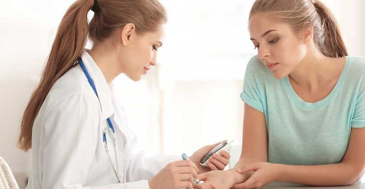 diabetic woman getting blood sugar test with medical professional doctor
